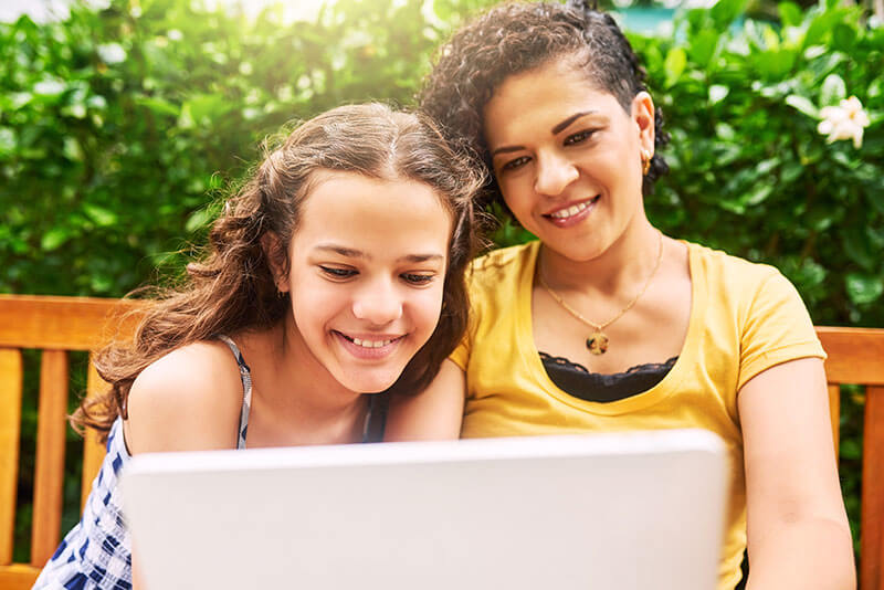 two teenage girls on a laptop